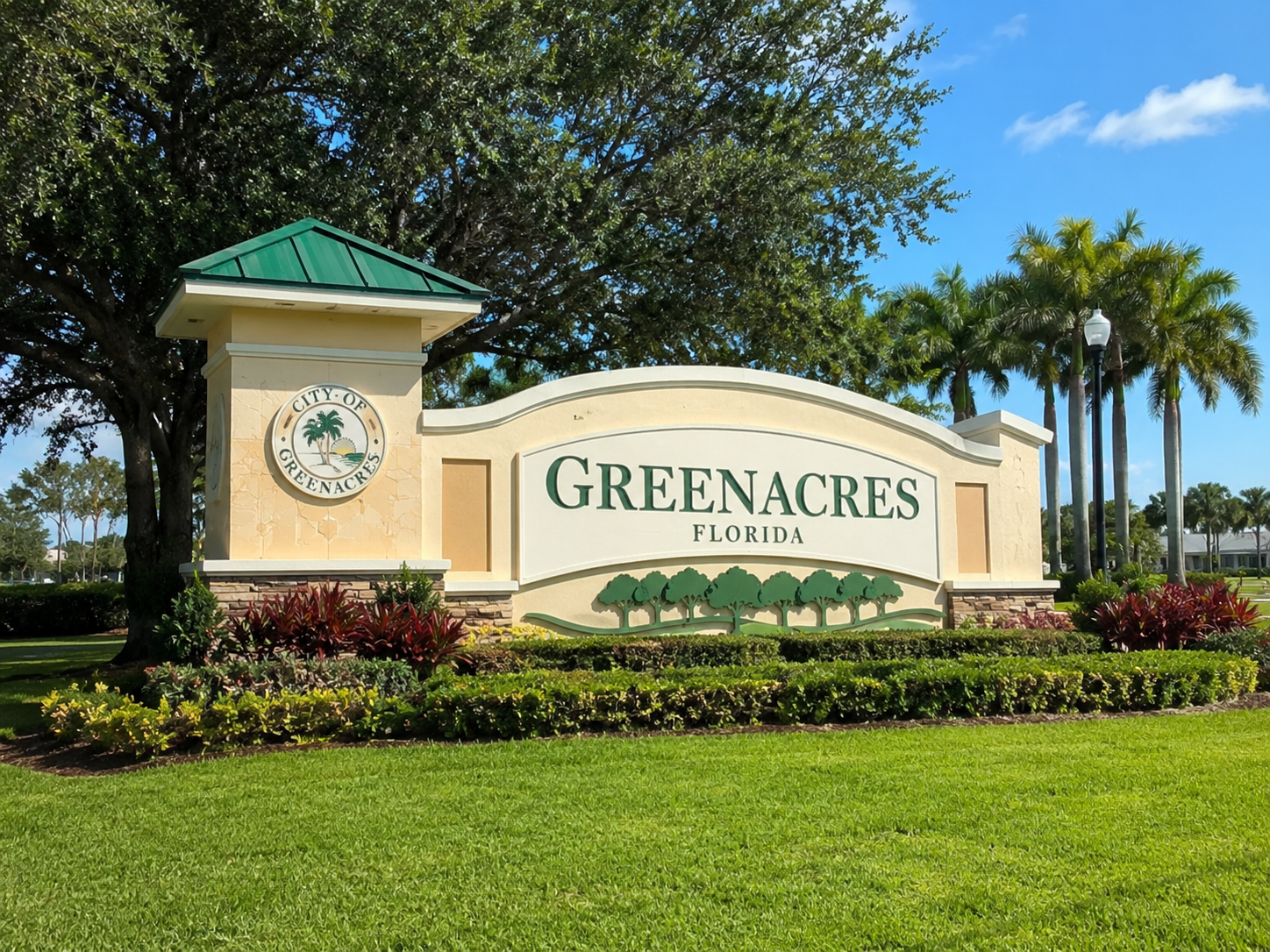 Greenacres Florida city entrance sign with palms and landscaped green space