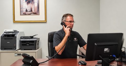 Mortgage advisor on a call at his desk at Mortgages Done Right